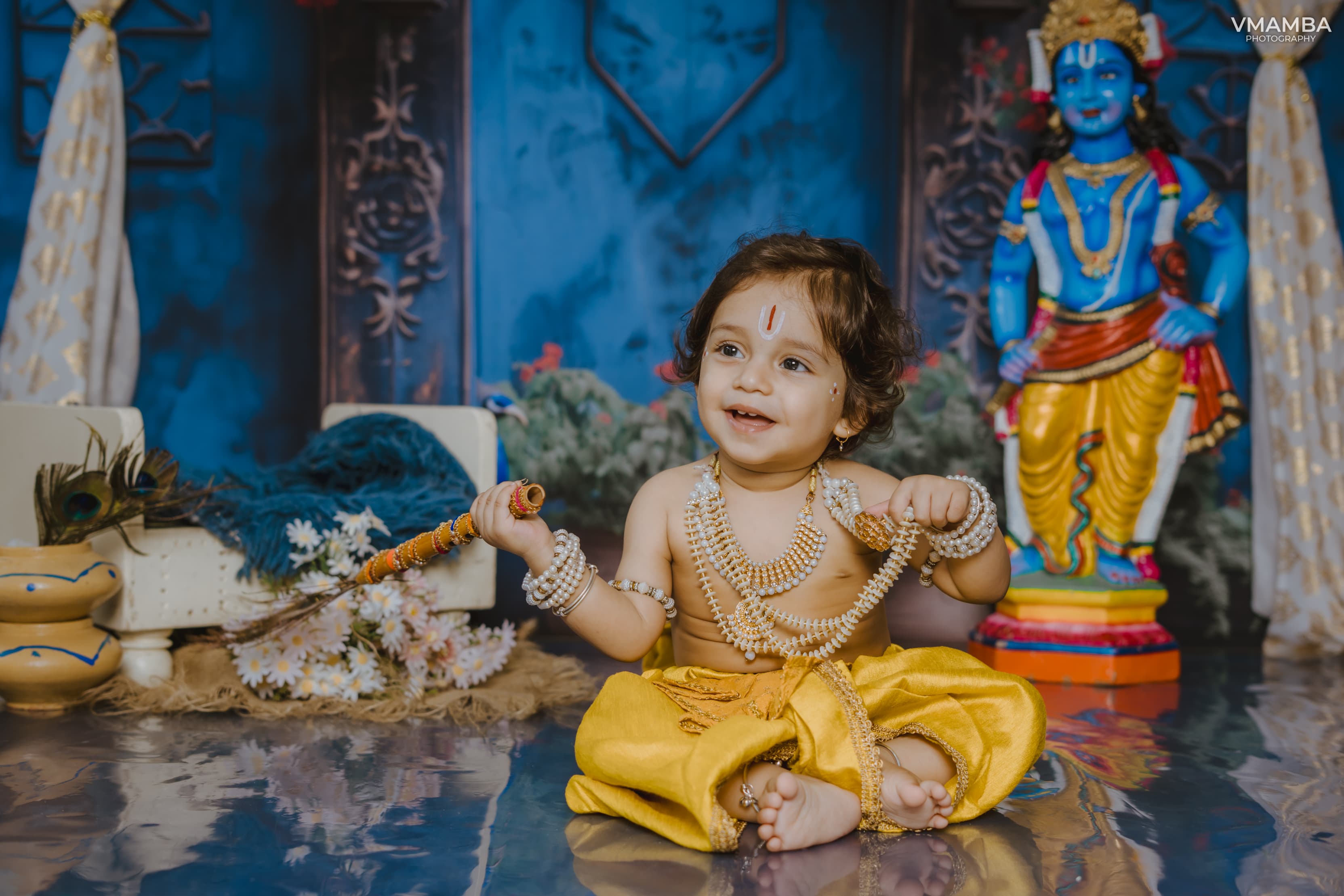 A joyful young participant dressed as Krishna